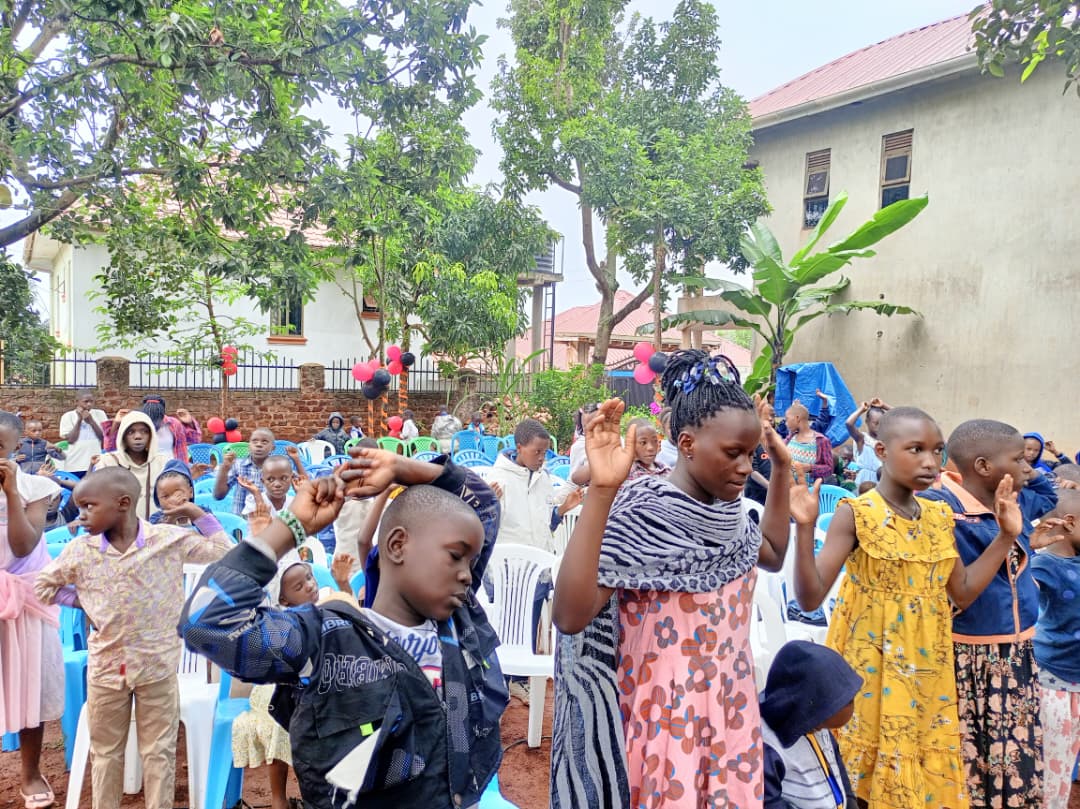 Children raising hands during LCMI ministry